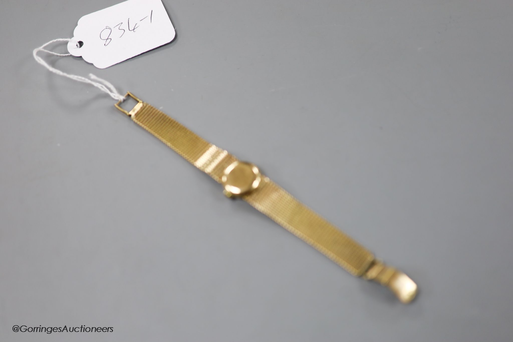 A lady's 9ct gold Omega Ladymatic wrist watch on integral 9ct gold Omega bracelet